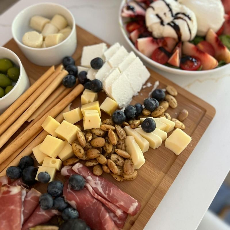 Cheese and charcuterie board filled with gourmet meats, cheeses, fruits, and crackers – a perfect appetizer for Christmas Day gatherings.