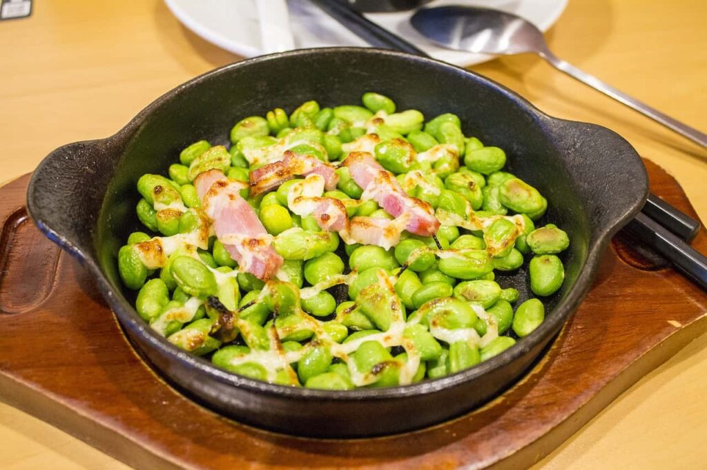 Steamed Edamame in a pan, a low-calorie Japanese snack packed with protein and fiber.