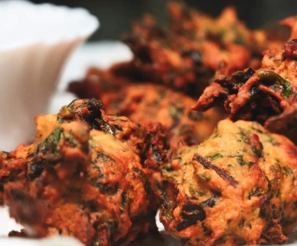 Pakoras - deep-fried crispy vegetable fritters with spinach, potatoes, and onions and made with gram flour batter. They're Mostly served with tea.